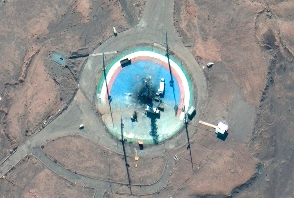 In this satellite photo from Maxar Technologies, trucks and other equipment surround a scorched launch pad at Iran's Imam Khomeini Spaceport in rural Semnan province Sunday, Feb. 27, 2022. (AP)