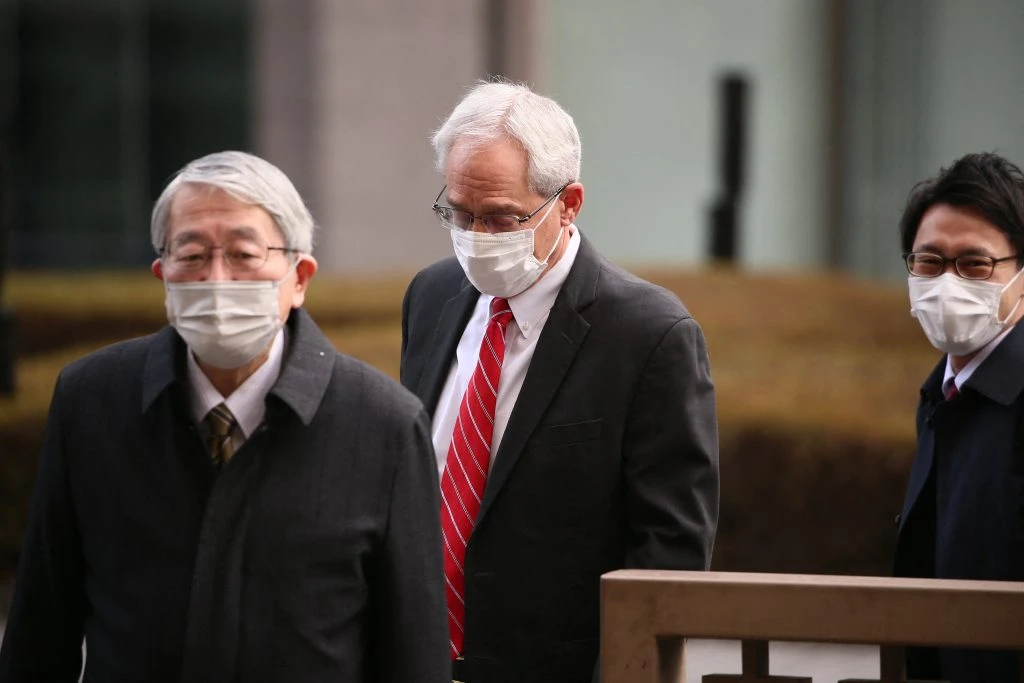 Greg Kelly, center, former executive of Japanese automaker Nissan, arrives at the Tokyo District Court in Tokyo Thursday, March 3, 2022. (AFP)