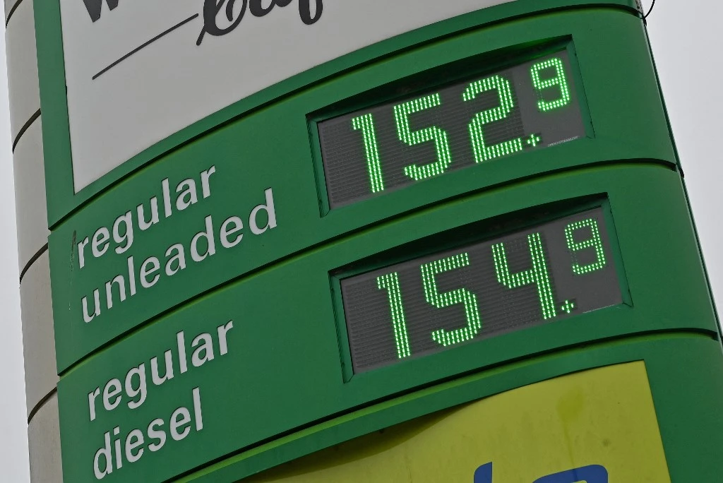 The price of petrol and diesel fuels are displayed on a board outside a petrol station at Emsworth Services near Portsmouth, in southern England on March 2, 2022. Oil prices soared Wednesday above $113 per barrel and natural gas hit a record peak. (AFP)