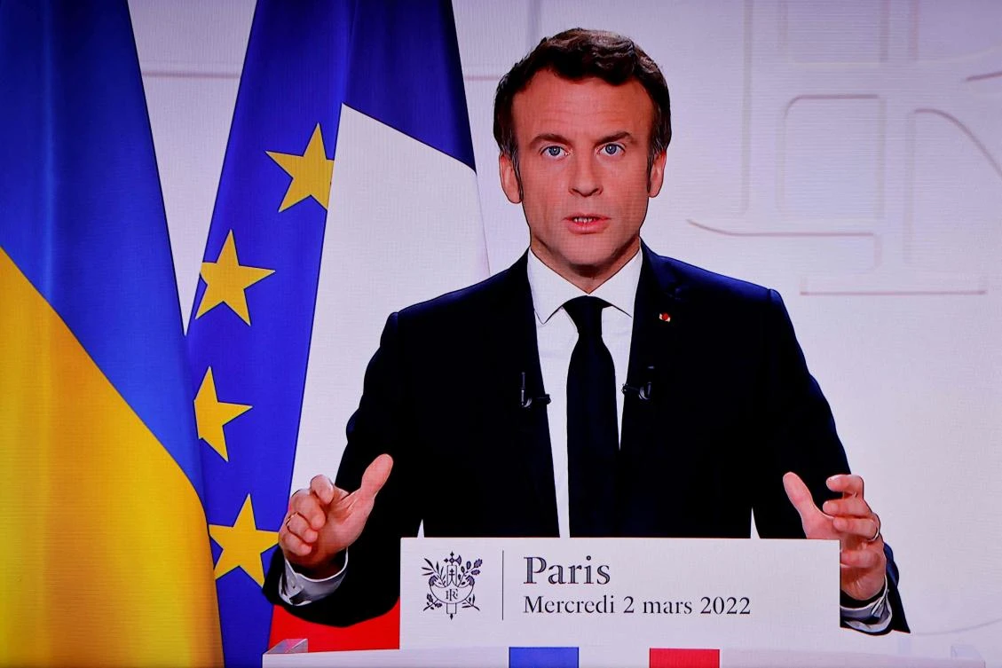A picture of a monitor taken in a media control room in Paris on Wednesday shows French President Emmanuel Macron during a televised address seven days after Russia launched a military invasion on Ukraine. (AFP)