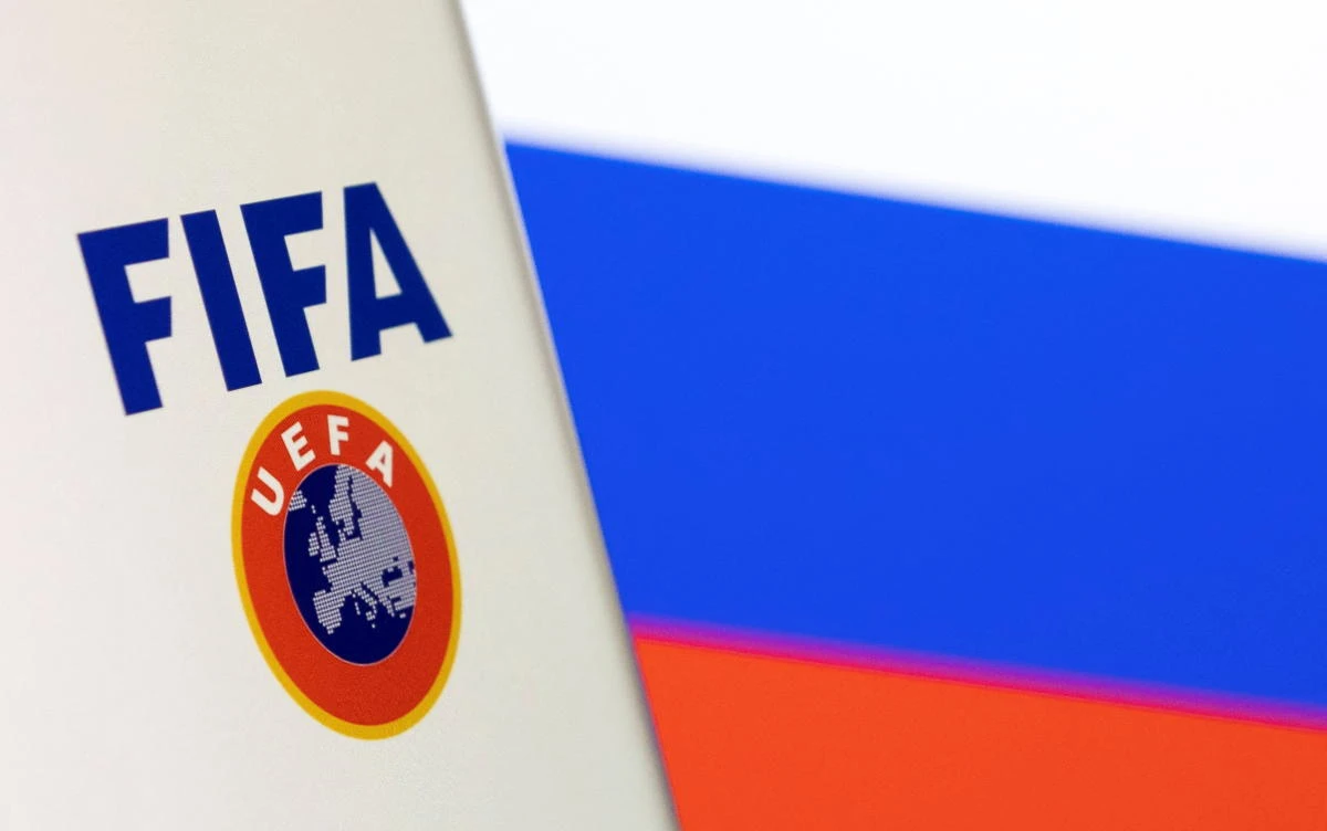 FIFA and UEFA logos are displayed in front of the Russian flag in this illustration taken on Monday. (Reuters)