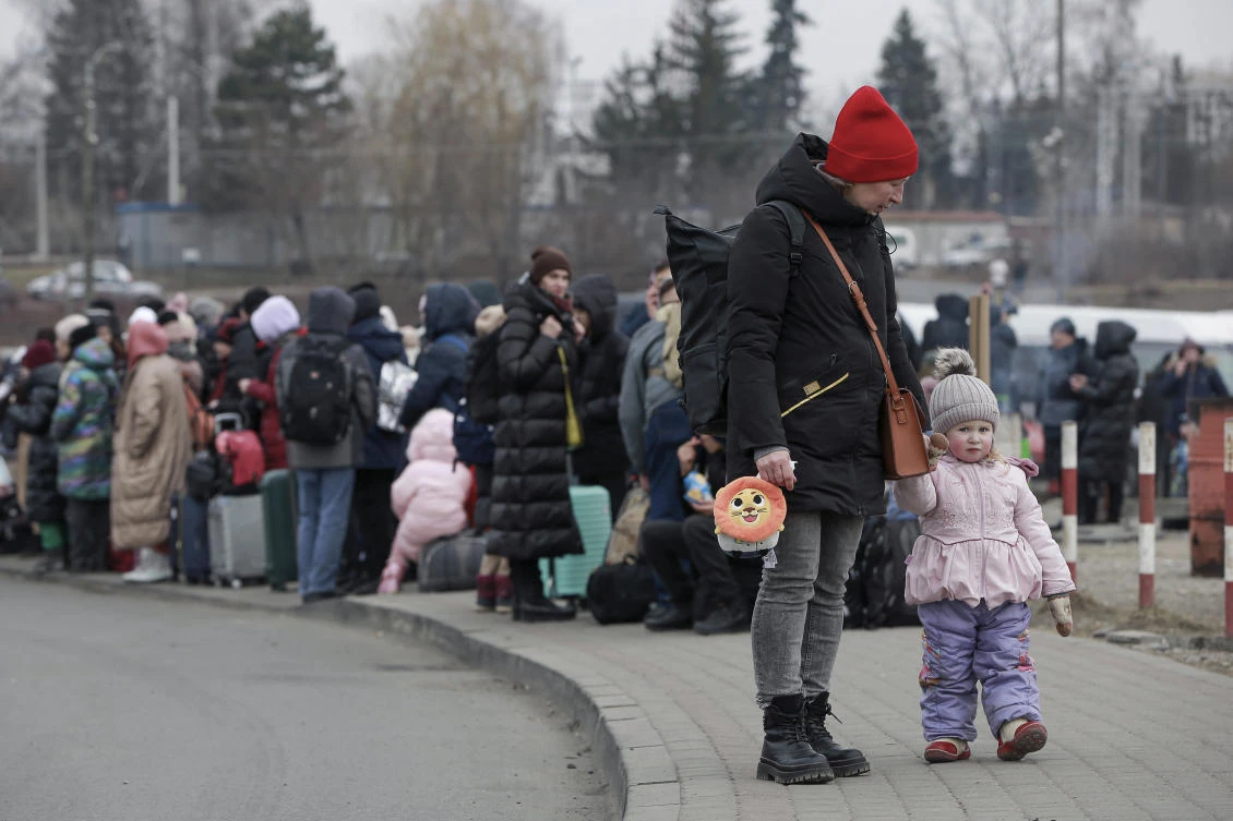 People who left Ukraine, wait for a bus to take them to the train station in Przemysl, at the border crossing in Medyka, Poland on Friday. (AP)