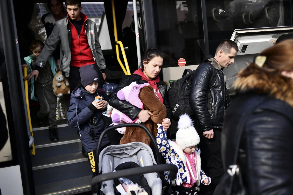 People fleeing from Ukraine arrive at a temporary shelter run by the municipality and the Baptist Charity in Tiszabecs, Hungary on Thursday. (AP)