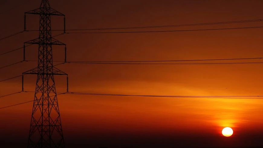 The sun sets behind high-voltage power lines and electricity pylons, northeast of Cairo, Egypt, March 13, 2019. (Reuters)