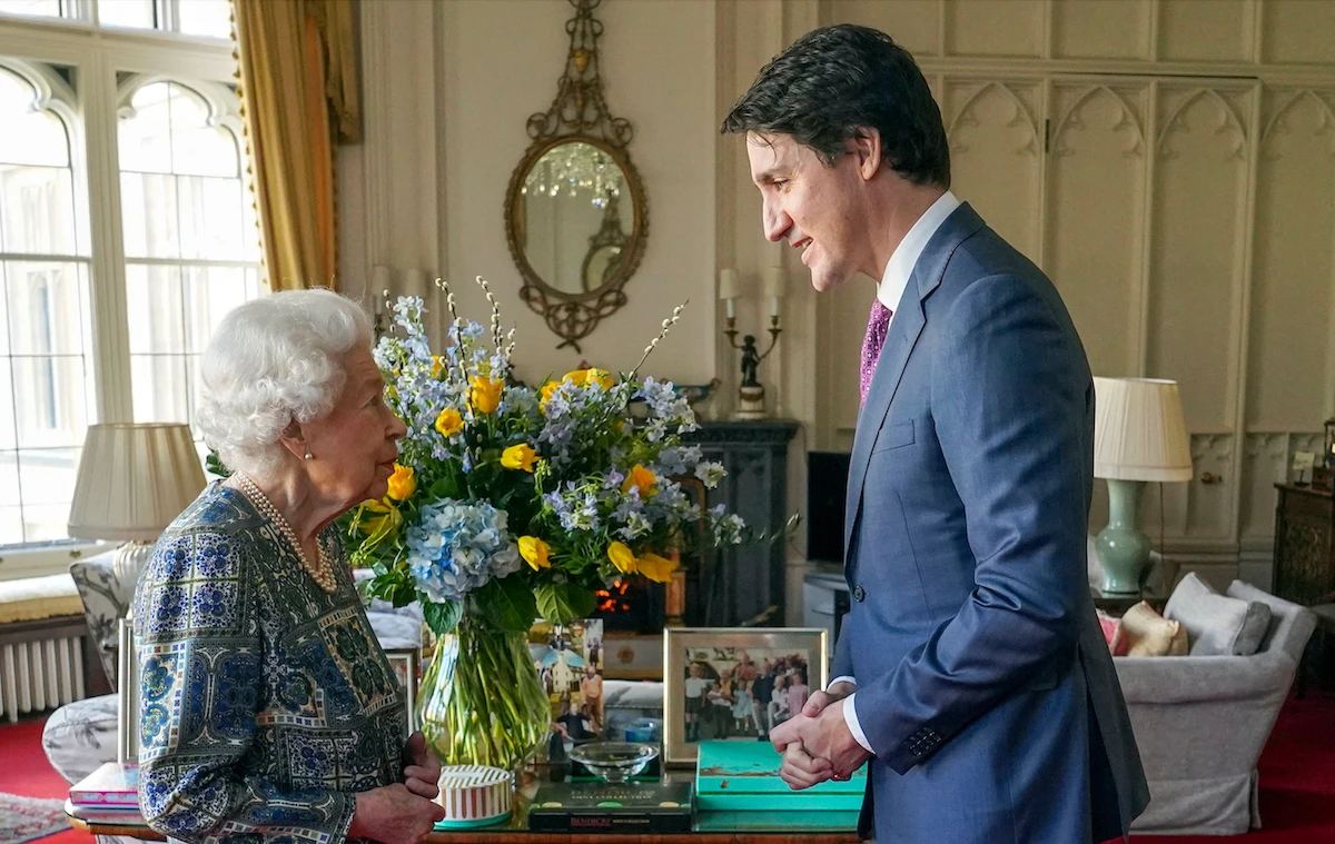 Britain's Queen Elizabeth II (L) speaks with Canadian Prime Minister Justin Trudeau during an audience at the Windsor Castle, Berkshire, on March 7, 2022. (AFP)