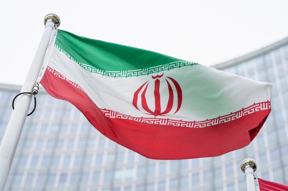 The flag of Iran waves in front of the International Center building with the headquarters of the International Atomic Energy Agency, IAEA, in Vienna, Austria. (AP)