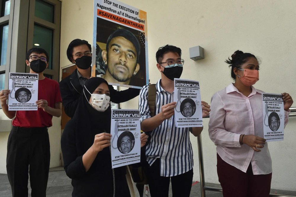 Activists hold posters against the execution of Nagaenthran Dharmalingam, sentenced to death for trafficking heroin into Singapore, outside the Singapore High Commision in Kuala Lumpur on Wednesday. (AFP)