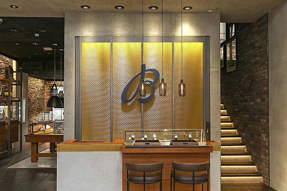The Watch Bar with its leather bar stools is a great spot to try on watches under the light of the hanging pendant bulbs, at the new Breitling boutique in Olaya Towers.