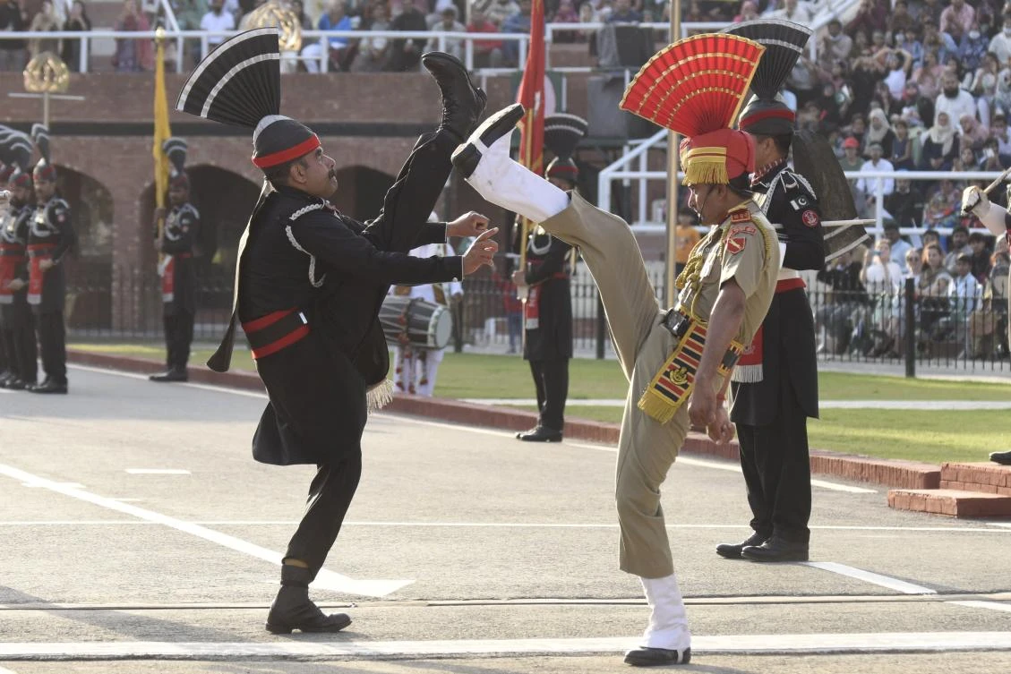 Above, Indian, right, and Pakistani border personnel take part in a retreat ceremony at the India-Pakistan Wagah border post on Mar. 9, 2022. (AFP)