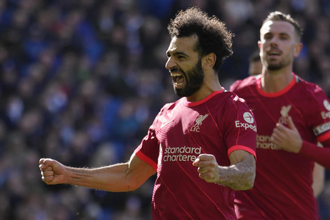 Liverpool’s Mohamed Salah celebrates after scoring his side’s second goal on a penalty kick during the Premier League match against Brighton and Hove Albion at the Amex stadium in Brighton on Saturday. (AP)