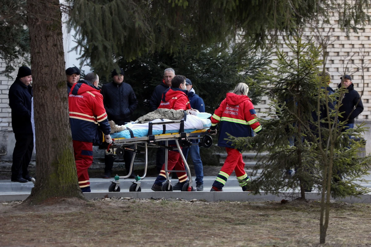 An injured serviceman is transported by medical workers, following an attack on the Yavoriv military base, amid Russia's invasion of Ukraine, at a hospital in Novoyavorivsk, Ukraine, March 13, 2022. (Reuters)