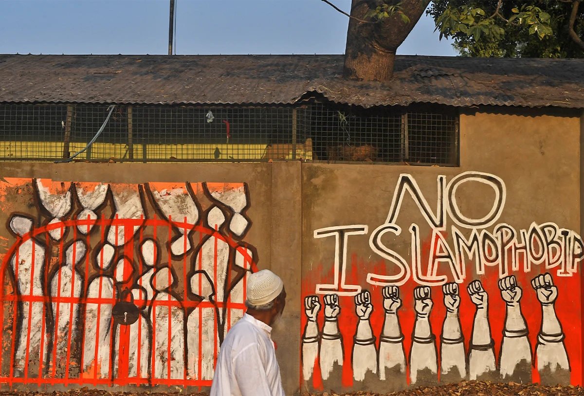 A man walks past a wall reading 'No Islamophobia' as a sign of protest against India's new citizenship law, in Kolkata, India, on February 14, 2020. (AFP/File)