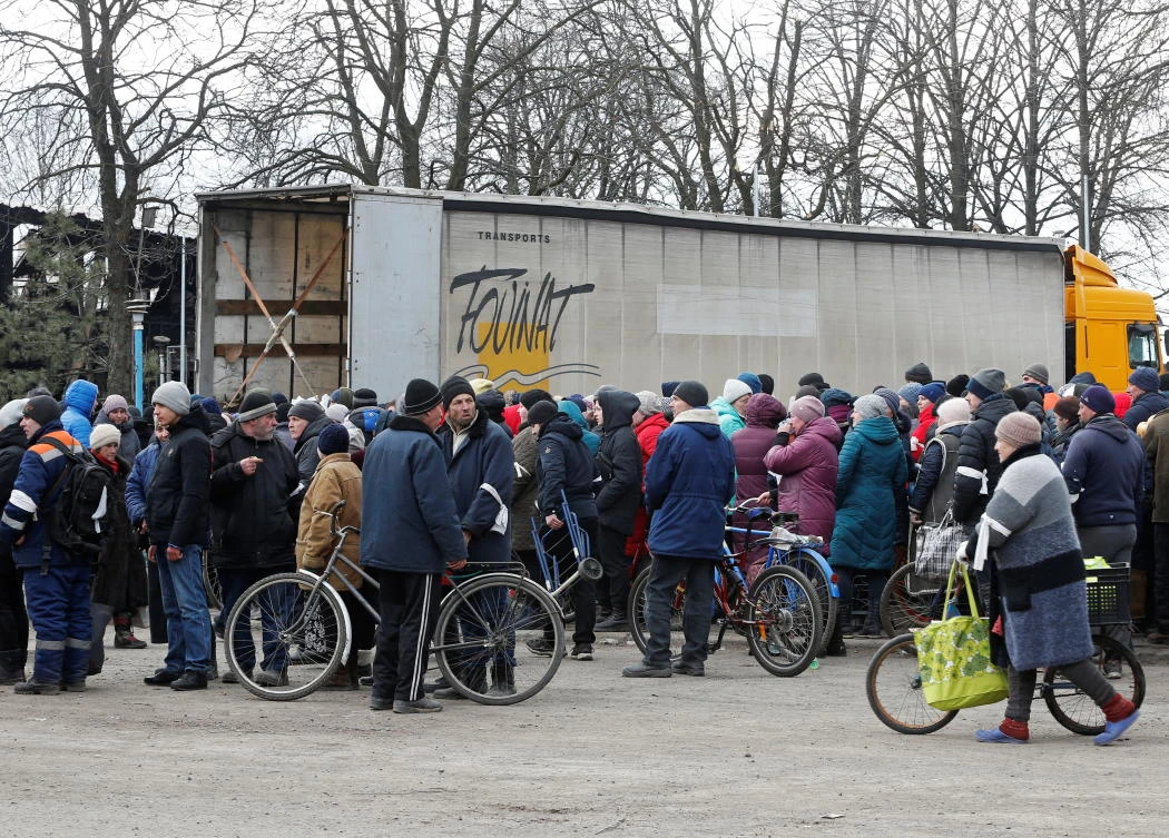 Local residents gather to receive humanitarian aid during Ukraine-Russia conflict in the separatist-controlled town of Volnovakha in the Donetsk region on Tuesday. (Reuters)
