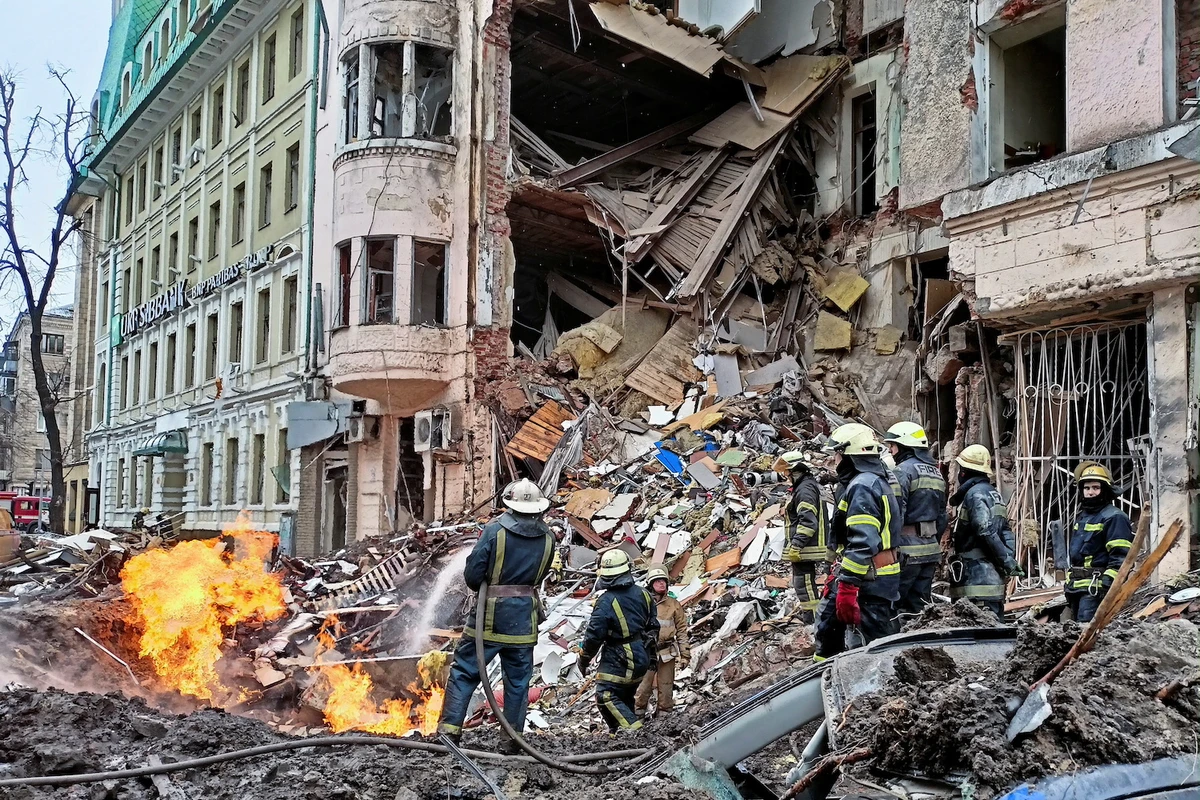 Rescuers work next to a building damaged by air strike, as Russia's attack on Ukraine continues, in central Kharkiv, Ukraine March 14, 2022. (Reuters)