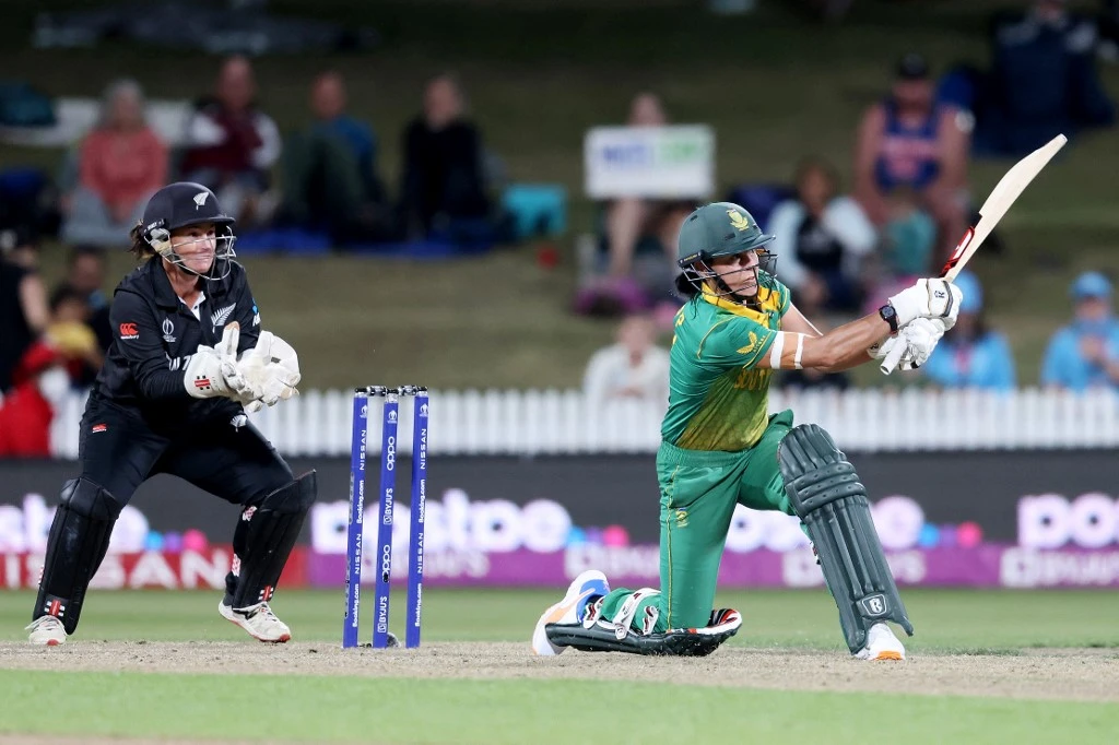 South Africa’s Marizanne Kapp, right, plays a shot watched by New Zealand’s wicketkeeper Katey Martin during a match at the 2022 Women’s Cricket World Cup at Seddon Park in Hamilton on March 17, 2022. (AFP)