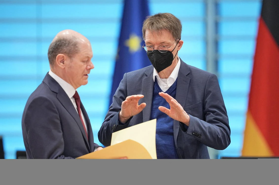 German Chancellor Olaf Scholz is listening to German Health Minister Karl Lauterbach during a closed session German government meeting in Berlin on Wednesday. (Reuters)