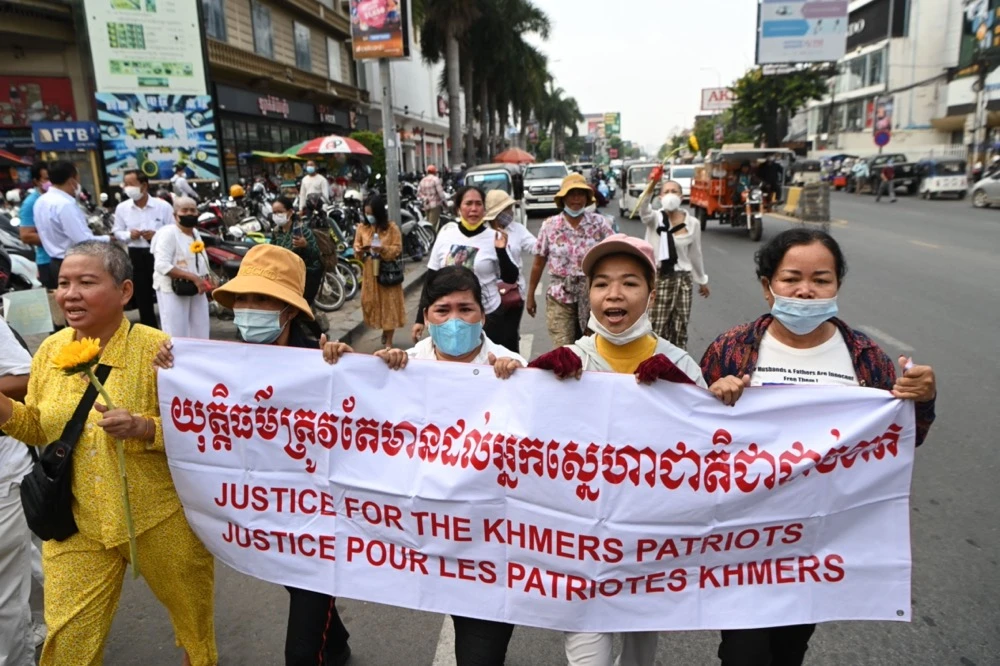 Relatives of jailed opposition members protest in front of Phnom Penh Municipal Court on Thursday, as the court sentenced opposition figures. (AFP)