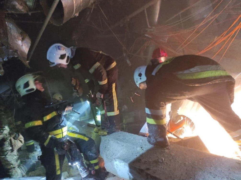 Firefighters search the debris of a shopping center following Russian shelling in Kyiv. (Ministry of Internal Affairs of Ukraine Press Service via AFP)