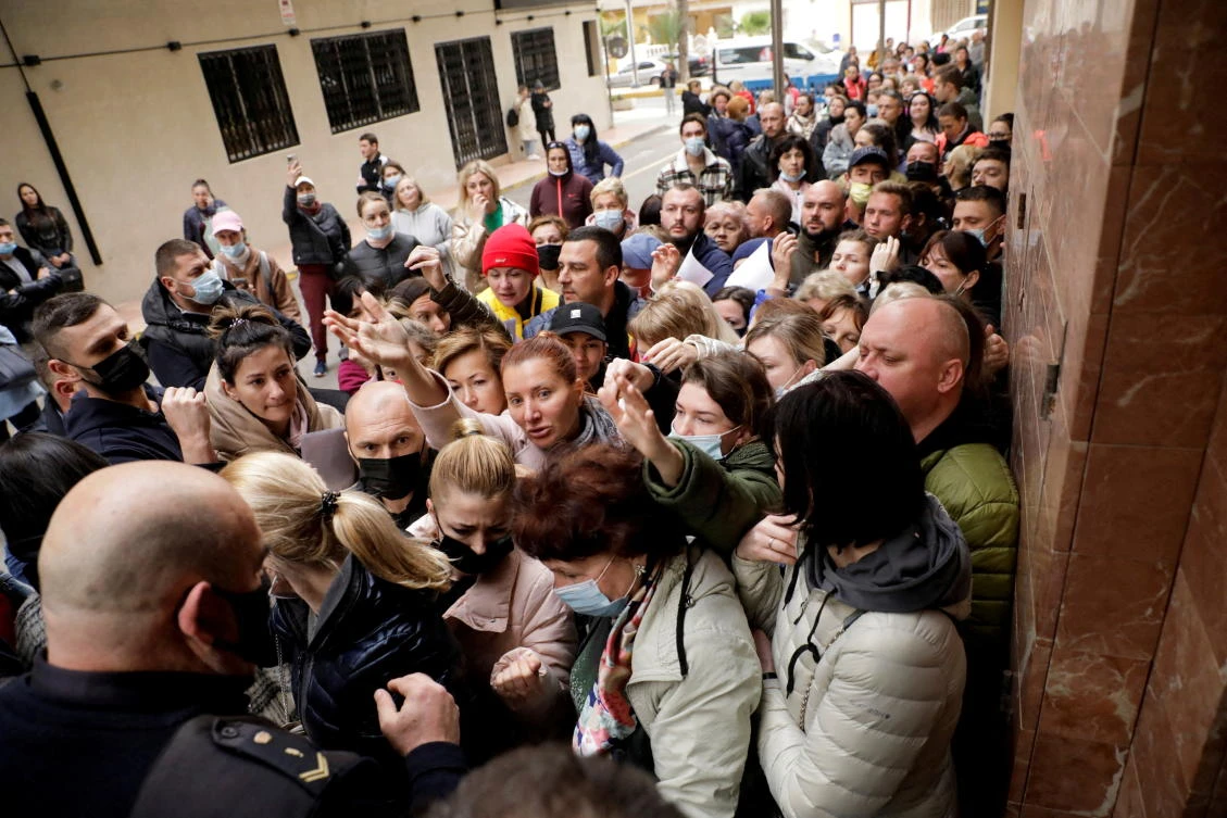 Ukrainian refugees queue to get one of the 100 daily appointments at the documentation office to apply for temporary protection approved by the EU in Torrevieja, Spain on March 15, 2022. (Reuters)