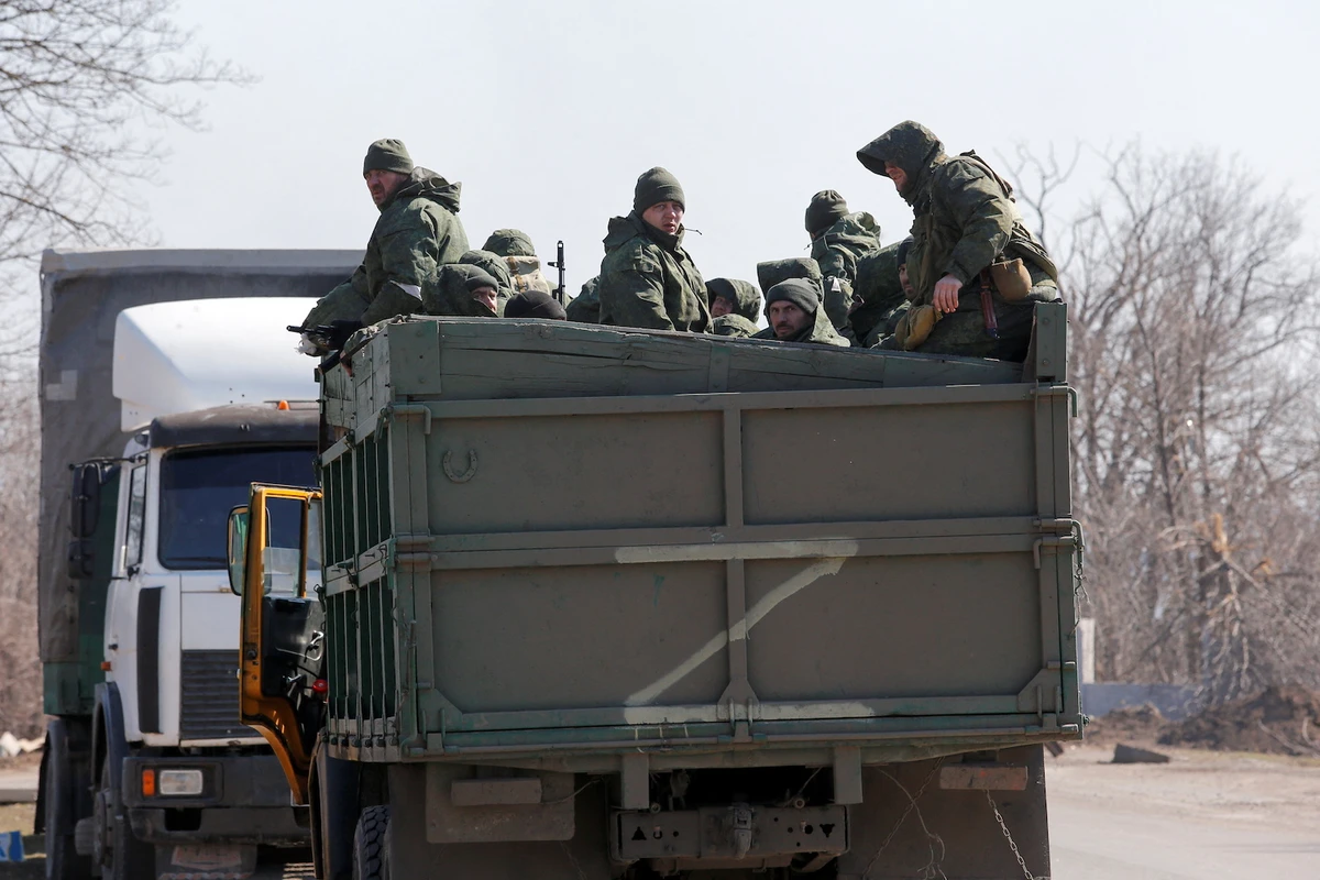 Service members of pro-Russian troops are seen in the body of a truck during Ukraine-Russia conflict on a road near Mariupol, Ukraine March 21, 2022. (Reuters)