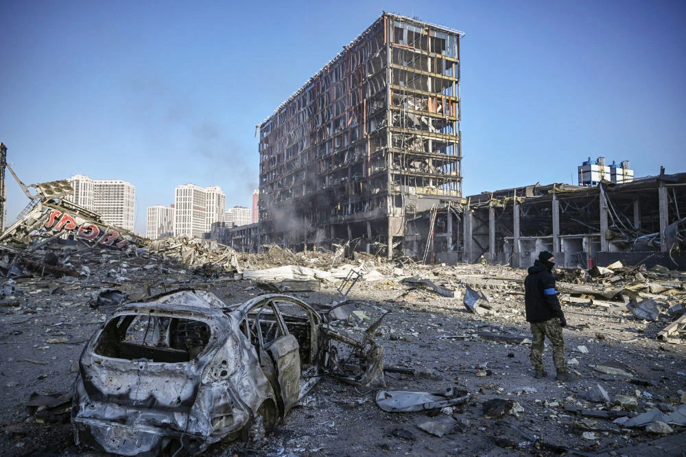 A Ukranian serviceman walks between debris outside the destroyed Retroville shopping mall in a residential district after a Russian attack on the Ukranian capital Kyiv on March 21, 2022. (AFP)