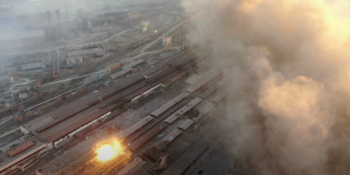 Multiple explosions and rising smoke are seen around an industrial compound in Mariupol, in this screengrab from video released on March 22, 2022. (Reuters)