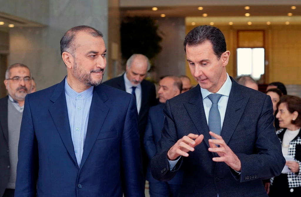 In this photo released by the Syrian official news agency SANA, shows Syrian President Bashar Assad, speaks with Iran’s Foreign Minister Hossein Amir-Abdollahian on Wednesday in Damascus. (AP)