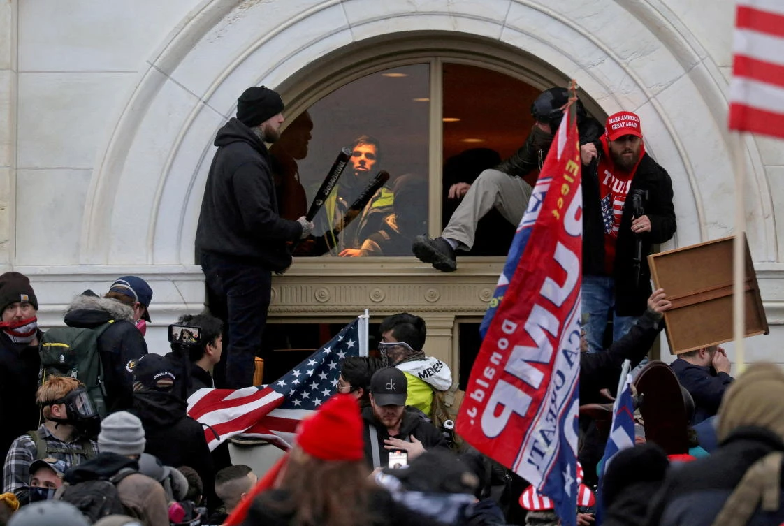 FILE PHOTO: A mob of supporters of then-US President Donald Trump climb through a window they broke as they storm the US Capitol Building in Washington in 2021. (Reuters)