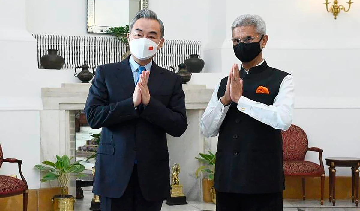 Indian Foreign Minister S. Jaishankar's Twitter, right, and his Chinese counterpart Wang Yi greet the media before their meeting in New Delhi, India, Friday, March 25, 2022. (AP)