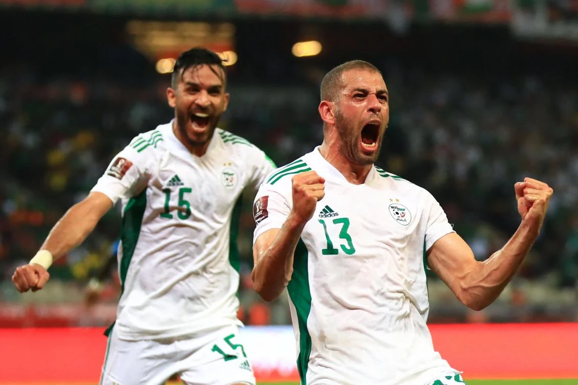 Algeria’s Islam Slimani celebrates a goal as teammate Abdelkader Bedrane looks on during their FIFA World Cup Qatar 2022 qualifying 3rd round match against Cameroon at Limbe Omnisport Stadium in Limbe on Friday. (AFP)