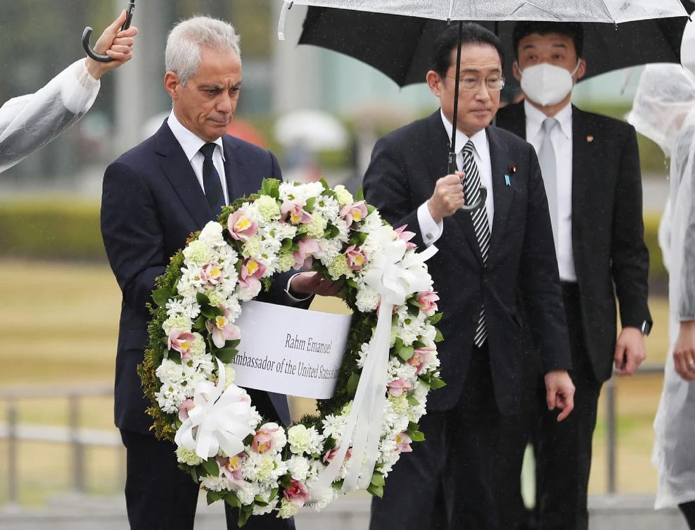 US ambassador to Japan Rahm Emanuel, left, is accompanied by Japanese Prime Minister Fumio Kishida as he lays a wreath at the Peace Memorial Park in Hiroshima on March 26, 2022. (Jiji Press/AFP)