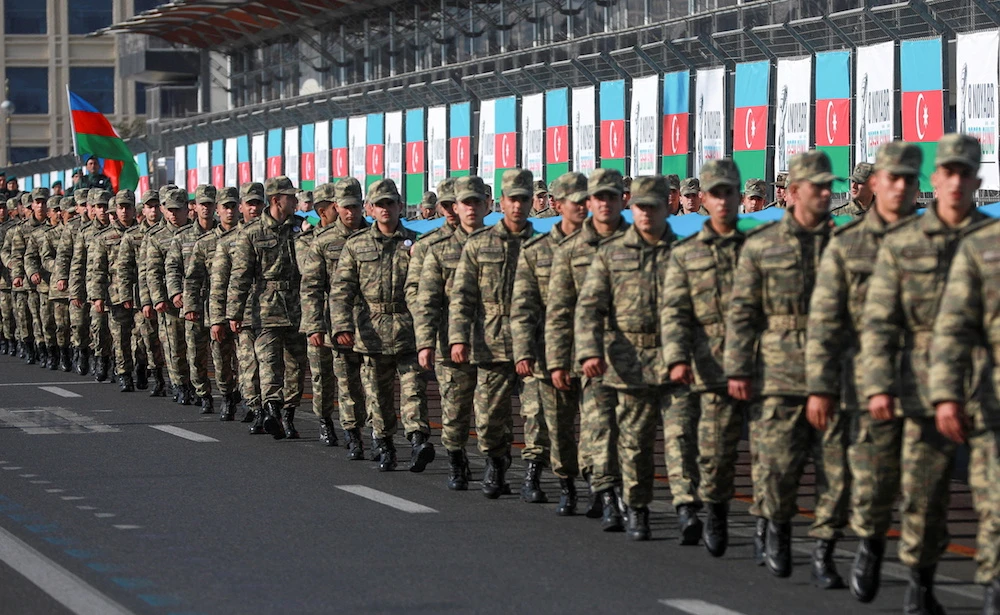 Azeri service members take part in a procession marking the anniversary of the end of the 2020 military conflict over Nagorno-Karabakh breakaway region. (Reuters/File Photo)