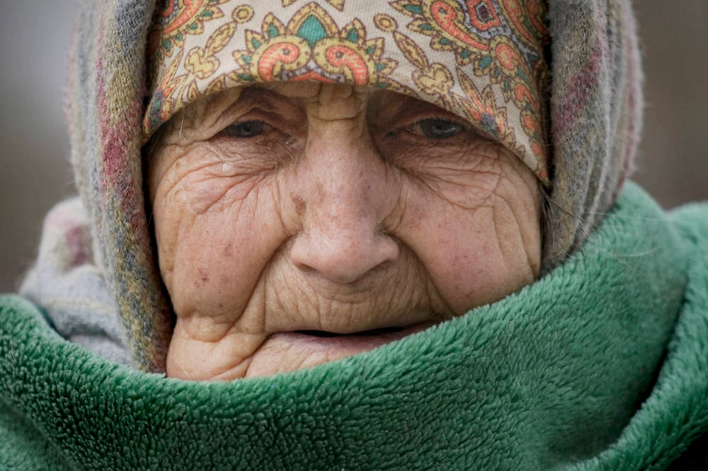 A 94 year-old woman cries wrapped in a blanket after being evacuated from Irpin on the outskirts of Kyiv, Ukraine, Saturday, March 26, 2022. (AP)