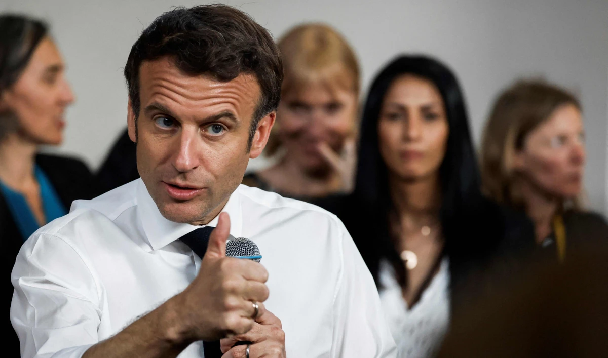 French incumbent president Emmanuel Macron meets representatives of associations working in the "Fontaine d'Ouche" neighborhood in Dijon, on March 28, 2022. (AFP)