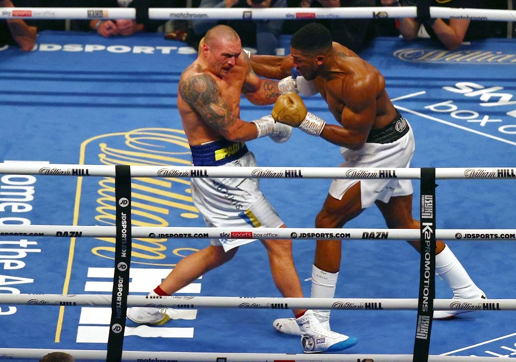 British heavyweight champion boxer Anthony Joshua (R) and Ukrainian boxer Oleksandr Usyk exchange punches during a heavyweight boxing match at Tottenham Hotspur Stadium, London. (File/AFP)