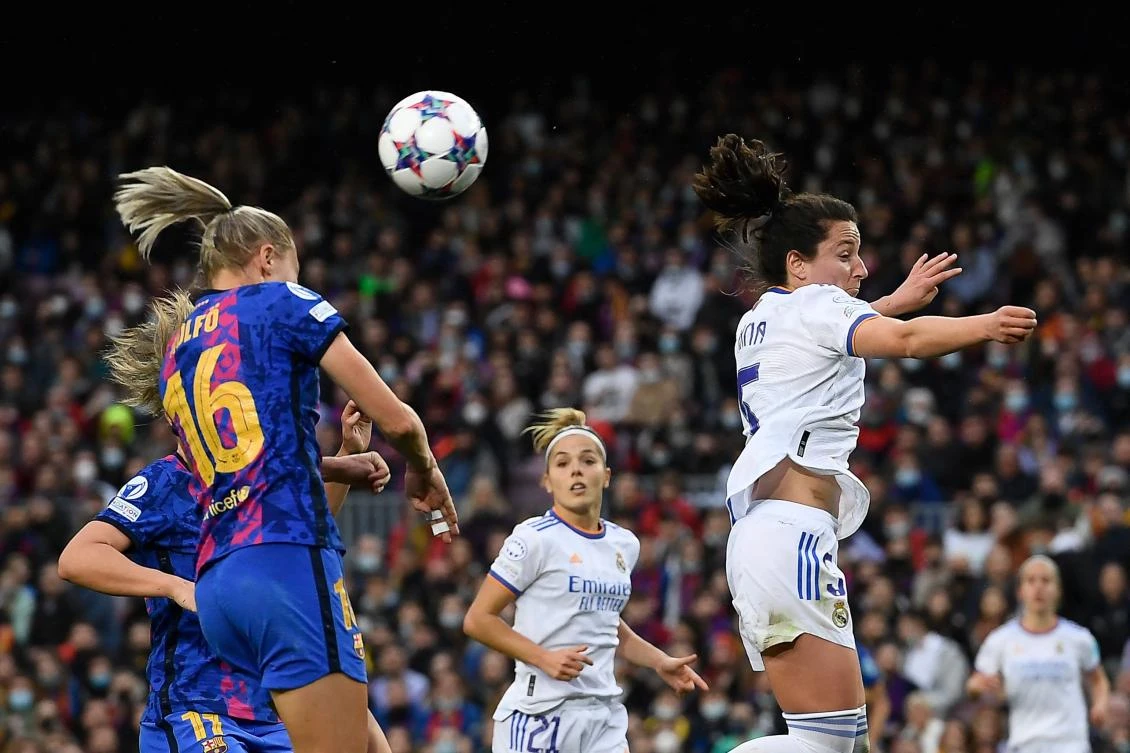 Barcelona’s Swedish forward Fridolina Rolfo and Real Madrid’s Spanish defender Ivana Andres jump for the ball during the women’s UEFA Champions League quarter final second leg match at the Camp Nou stadium in Barcelona on Wednesday. (AFP)
