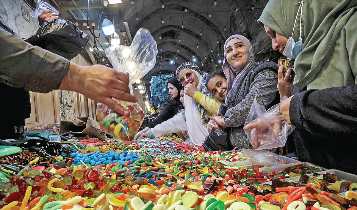 Palestinians shop for sweets amid preparations before the start of the holy month of Ramadan. (AFP)