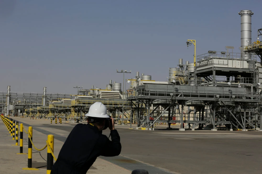 A photographer takes pictures of the Khurais oil field during a tour for journalists, 150 km east-northeast of Riyadh, Saudi Arabia. (AP/File)