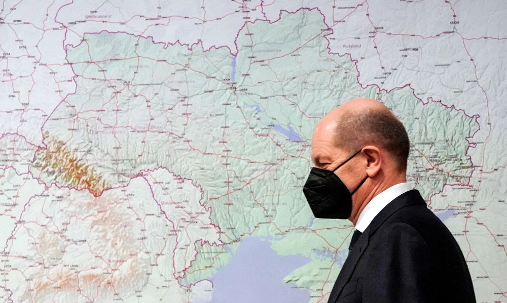 Olaf Scholz walks by a map of Ukraine at the Bundeswehr Operations Command in Schwielowsee, Germany, Mar. 4, 2022. (Reuters)