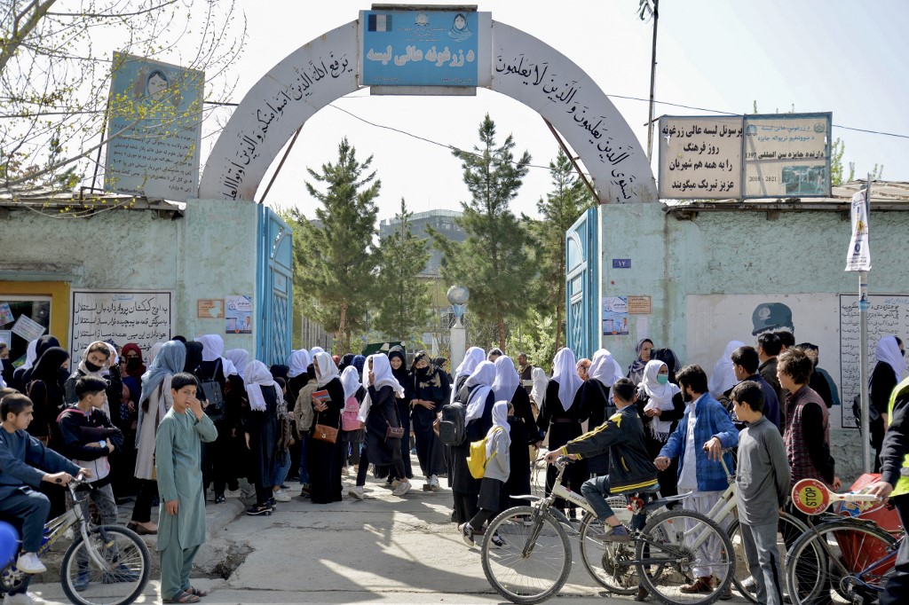 Girls leave their school following a closure order just hours after reopening in Kabul on March 23, 2022. (AFP)