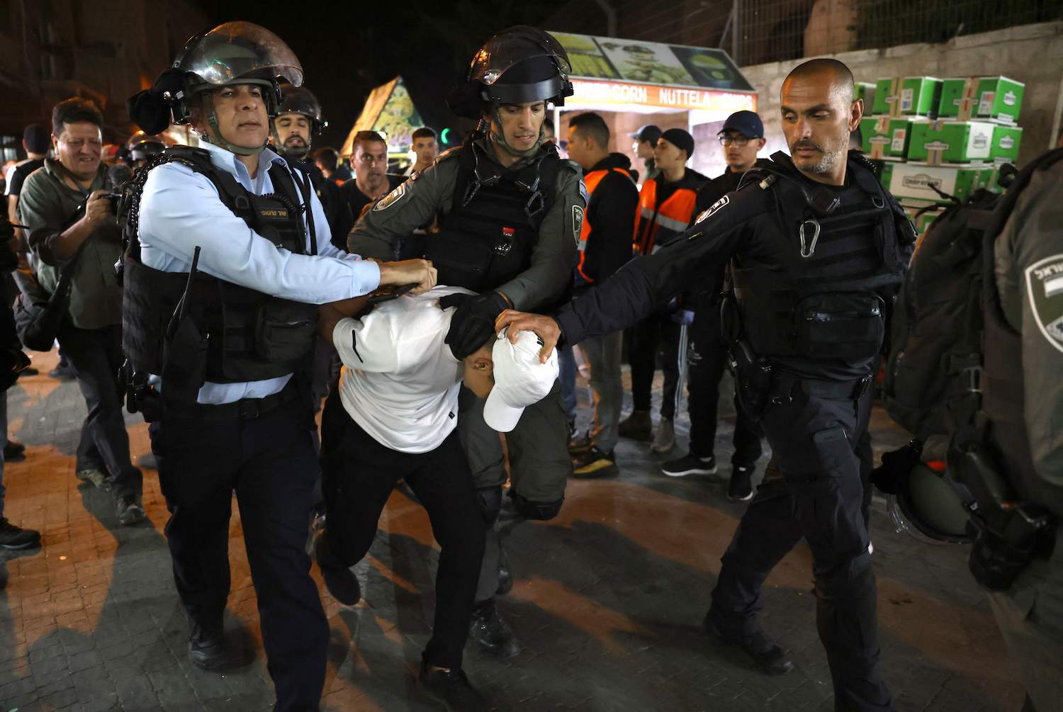 Israeli security forces detain a Palestinian youth outside Damascus Gate in Jerusalem's Old City on April 5, 2022 during the Muslim holy fasting month of Ramadan. (AFP)