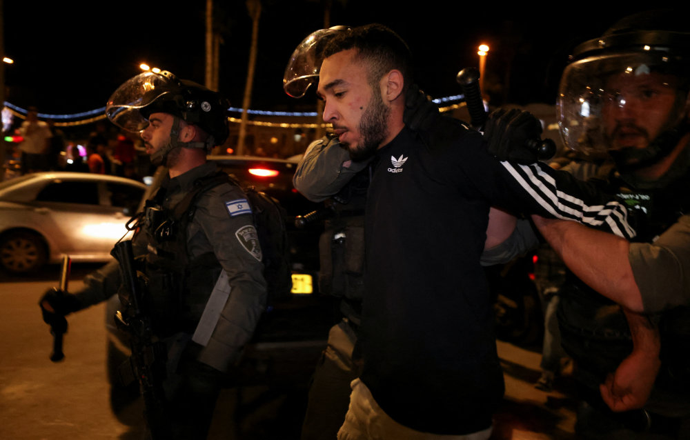 Israeli security force members detain a protester during clashes between Israeli security forces and Palestinians at Damascus Gate by the entrance to Jerusalem's Old City April 4, 2022. (Reuters)