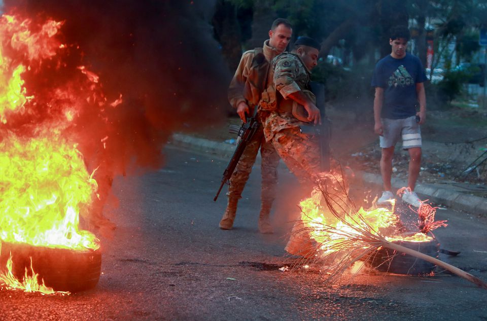 Lebanese soldiers attempt to open a road that was blocked by demonstrators during a protest against deteriorating living conditions, Sidon, Lebanon, Nov. 29, 2021. (Reuters)