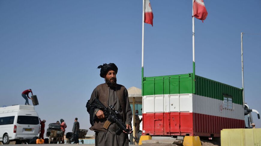 A Taliban fighter stands guard at the Islam Qala border crossing between Iran and Afghanistan, Oct. 19, 2021. (AFP)