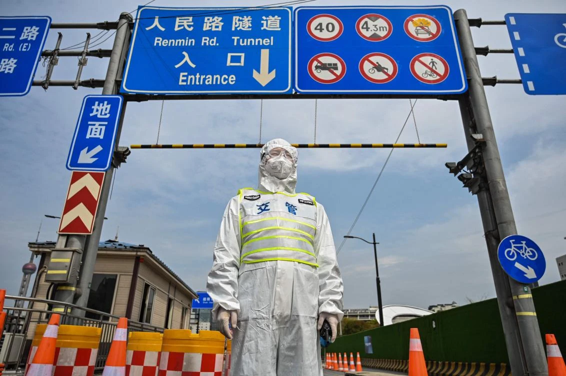 A transit officer controls access to a tunnel in the direction of Pudong district in lockdown as a measure against the COVID-19 coronavirus in Shanghai on March 28, 2022. (AFP)