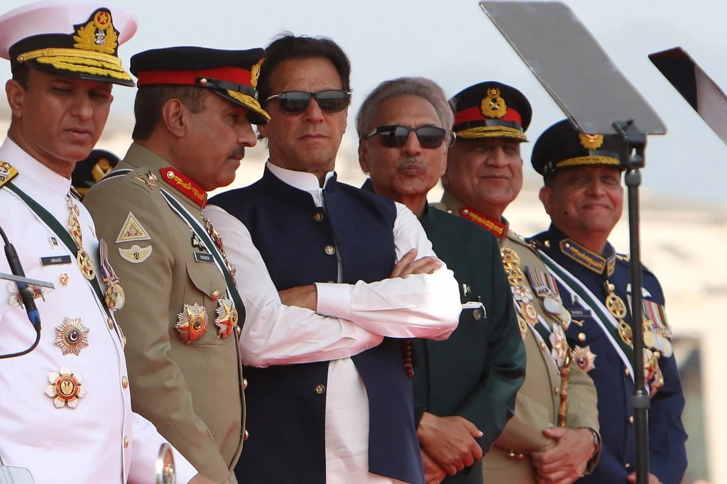Pakistan’s Prime Minister Imran Khan, center left, and President Arif Alvi, center right, watch air force fighter jets perform during the Pakistan Day parade in Islamabad on March 23, 2022. (AFP)