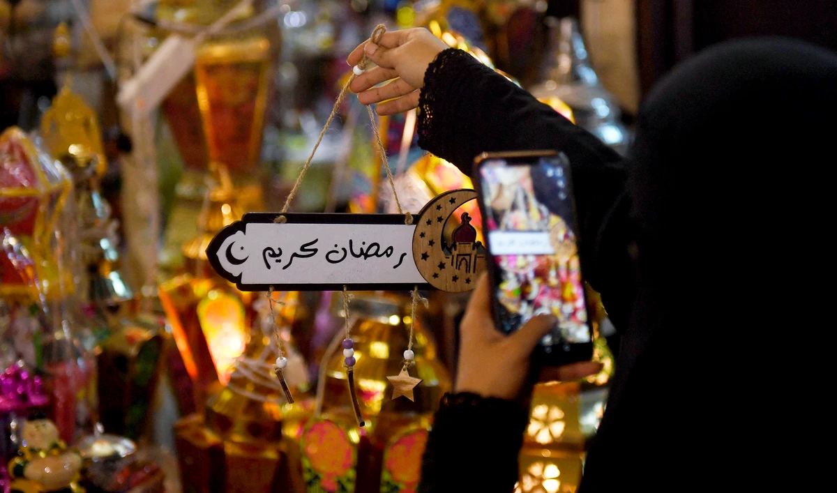 A Saudi woman takes a picture of decorations in the Saudi coastal city of Jeddah on May 3, 2019, ahead of the Muslim holy fasting month of Ramadan. (AFP/File)