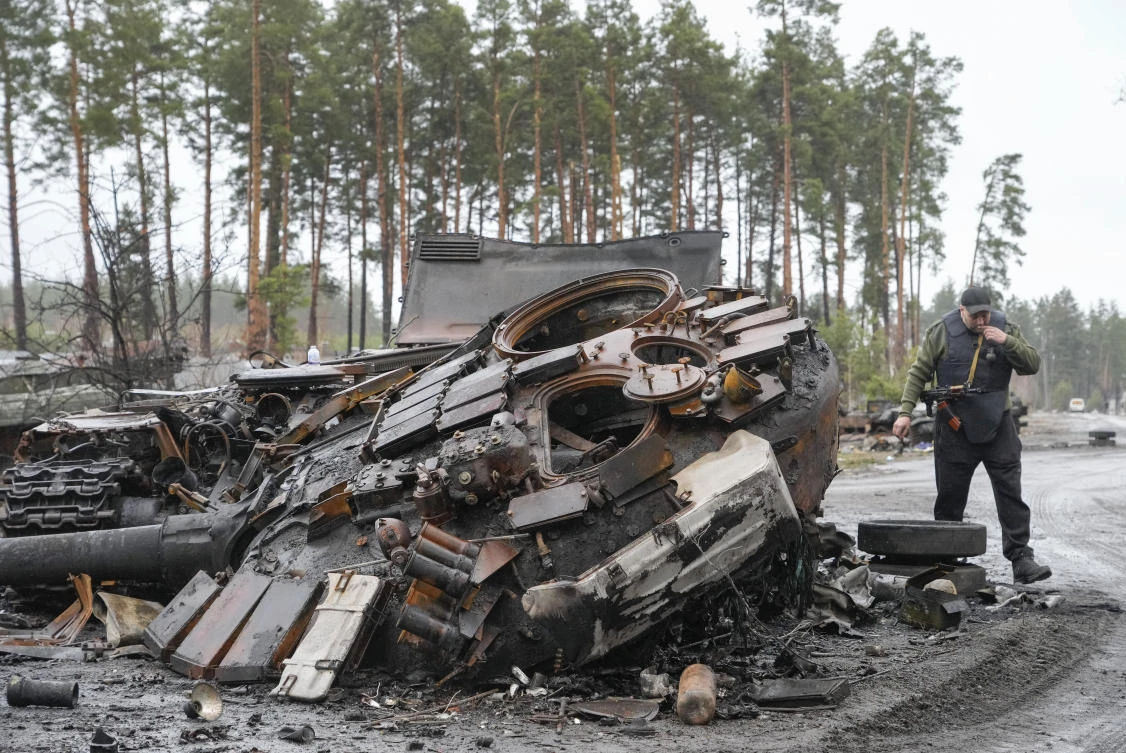 A Ukrainian soldier passes by destroyed Russian tanks in the village of Dmytrivka close to Kyiv, Ukraine, Saturday, Apr. 2, 2022. (AP)