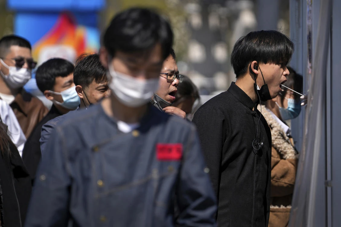 Notices delivered to residents said they were required to self-test for COVID-19 daily and take precautions including wearing masks at home and avoiding contact with family members. (AP)