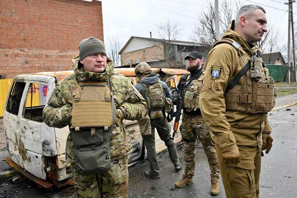 Kyiv's Mayor Vitali Klitschko (R) talks with people in the town of Bucha, near the Ukrainian capital Kyiv on April 3, 2022. (AP)